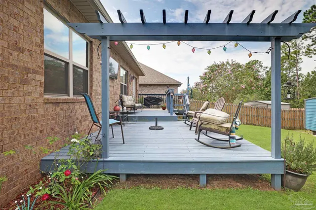 a view of a house with a yard and a patio