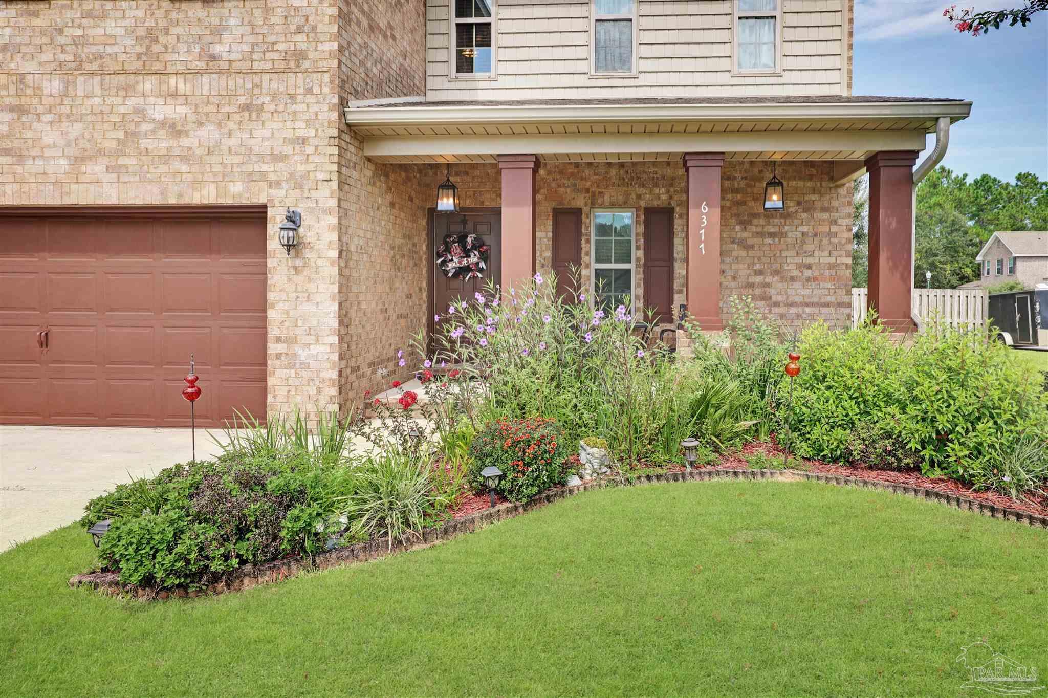 6377 Ladera Trail Pace, FL 32571 - Photo 3 of 38 front view of a house with a yard