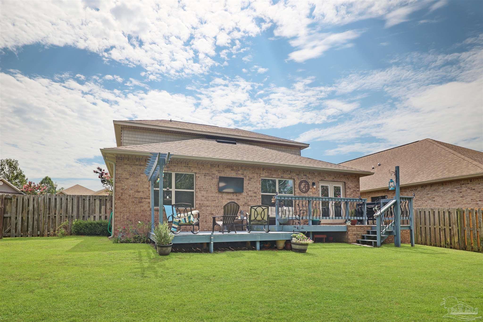 6377 Ladera Trail Pace, FL 32571 - Photo 31 of 38 a view of a house with a yard and a patio