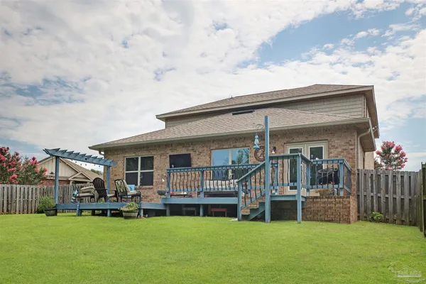 an aerial view of a house with swimming pool having outdoor seating