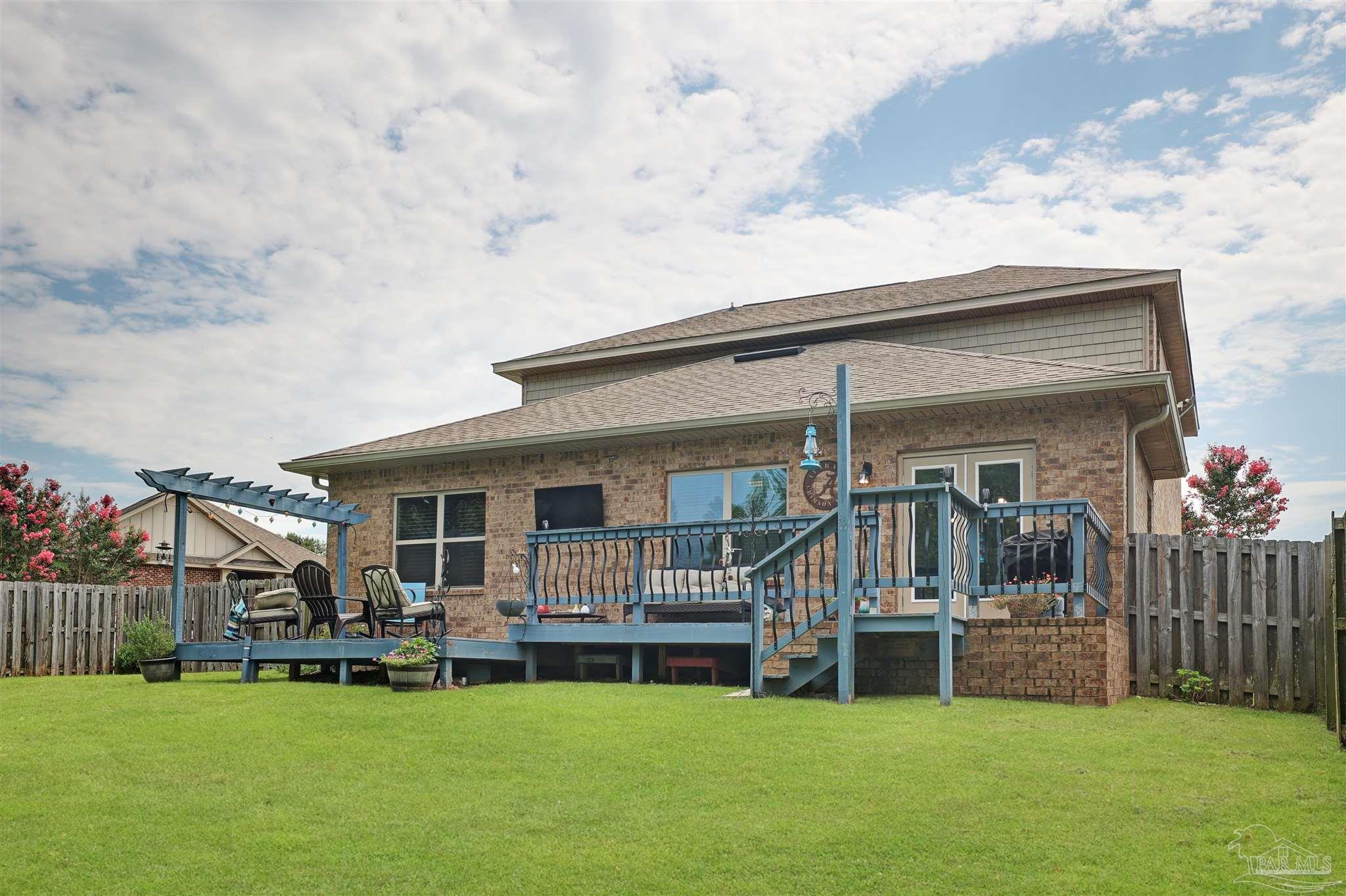 6377 Ladera Trail Pace, FL 32571 - Photo 32 of 38 a view of a house with sitting area and garden