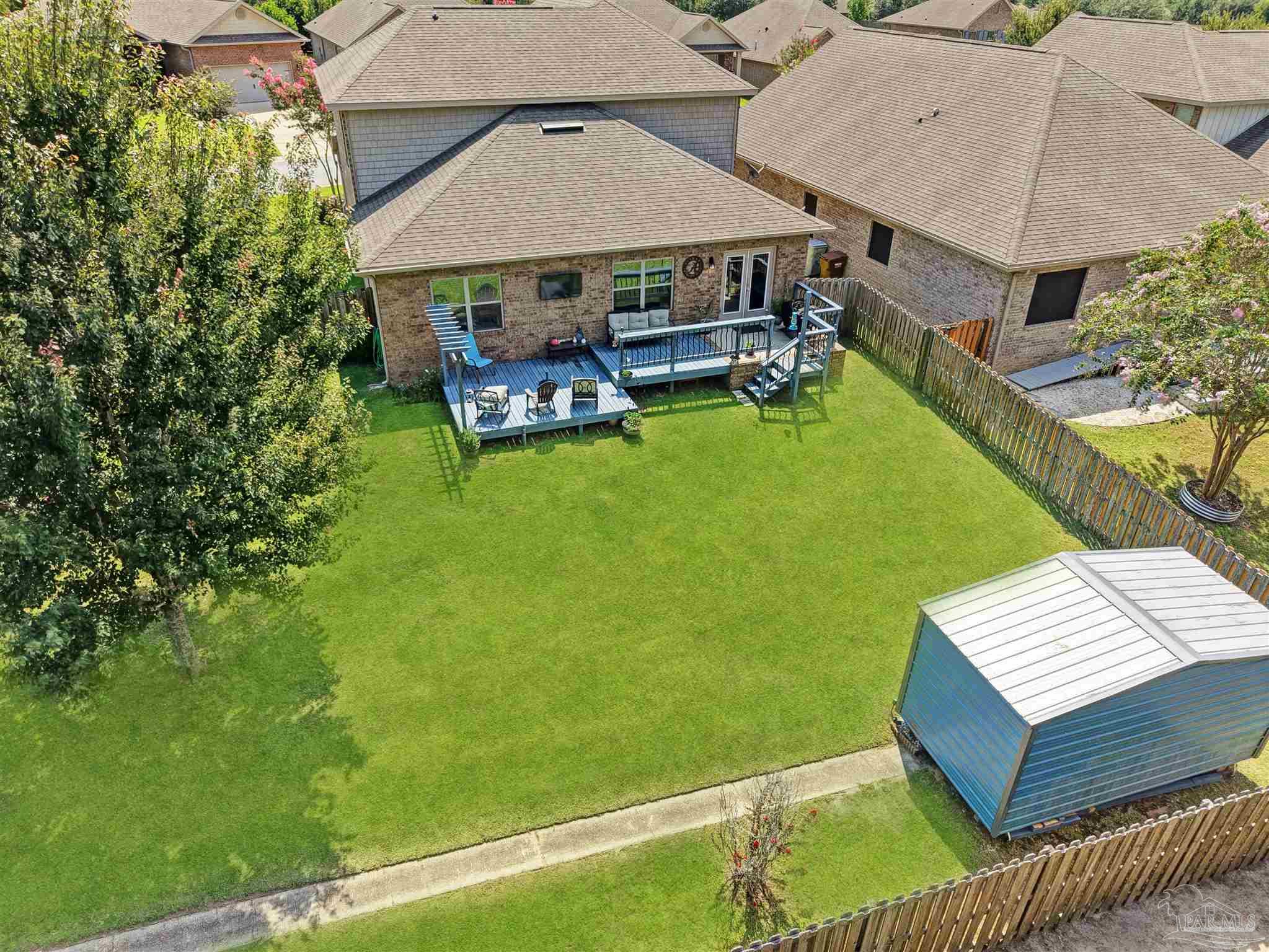 6377 Ladera Trail Pace, FL 32571 - Photo 33 of 38 an aerial view of a house having patio with a garden