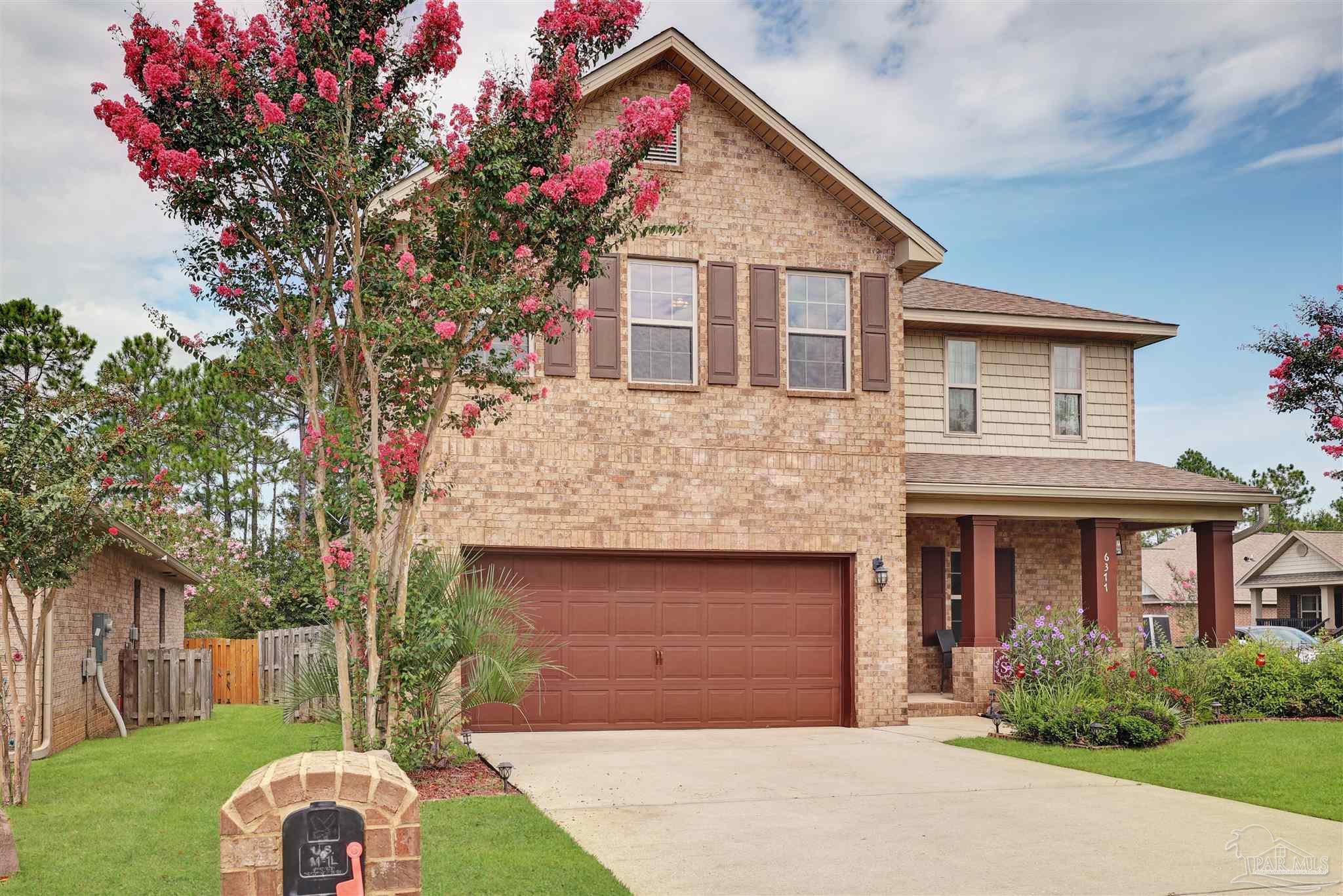 6377 Ladera Trail Pace, FL 32571 - Photo 36 of 38 a front view of a house with a yard