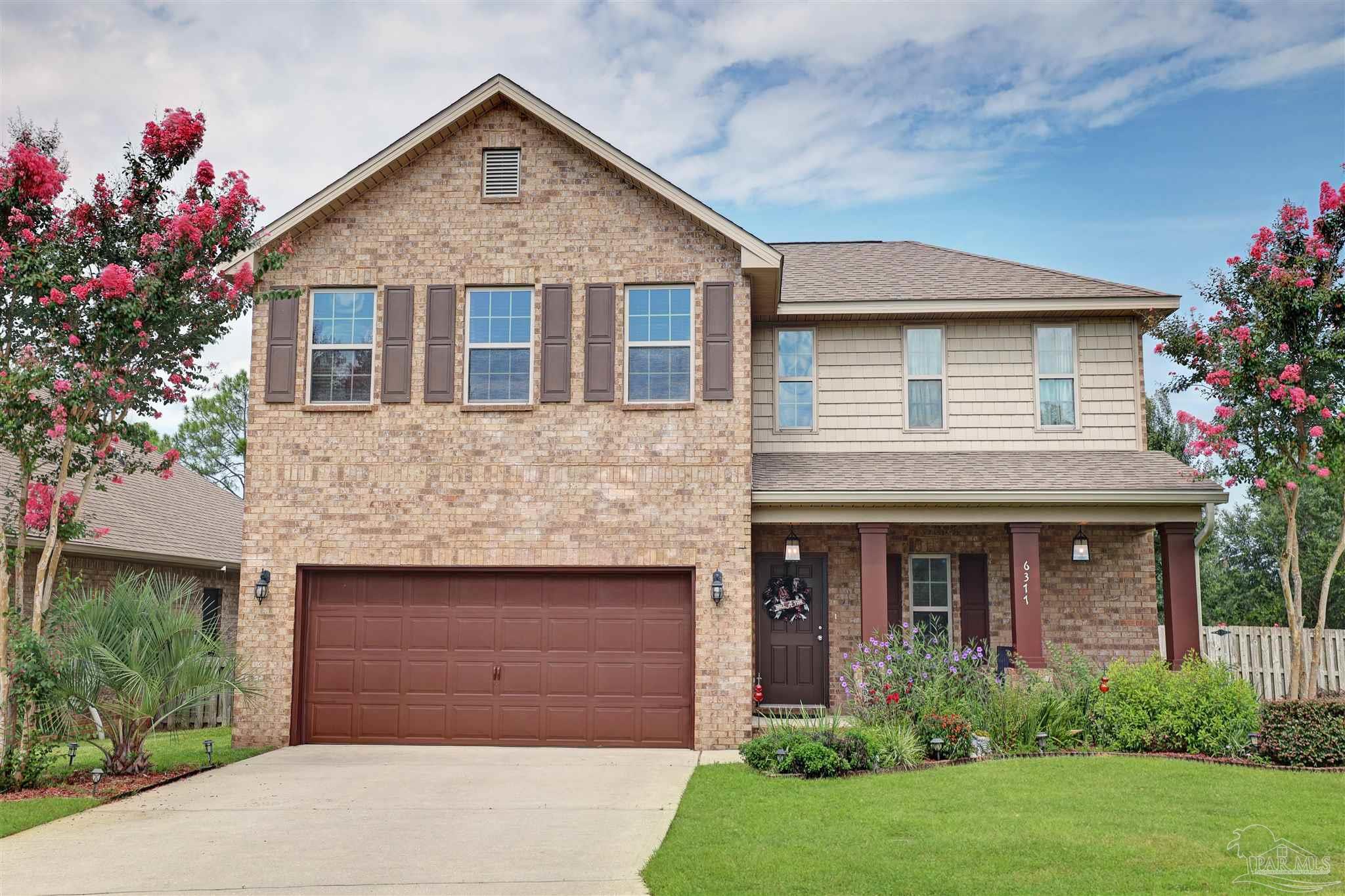 6377 Ladera Trail Pace, FL 32571 - Photo 37 of 38 a front view of a house with a garden