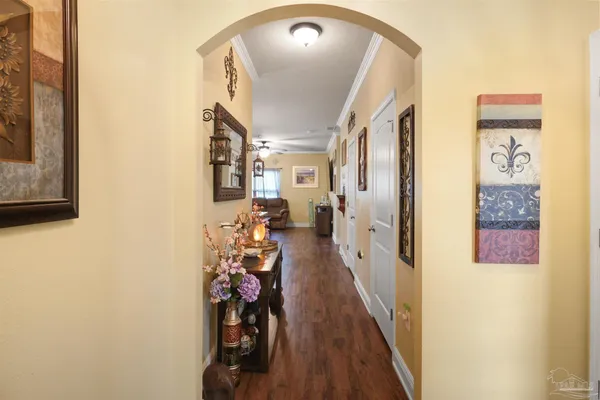 a view of a hallway with entryway to a livingroom