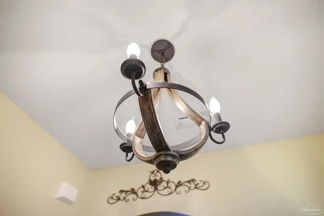 a picture of a wall with a chandelier fan and a mirror