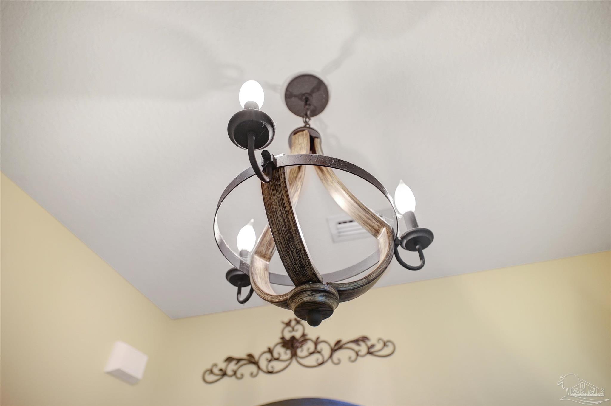6377 Ladera Trail Pace, FL 32571 - Photo 5 of 38 a picture of a wall with a chandelier fan and a mirror