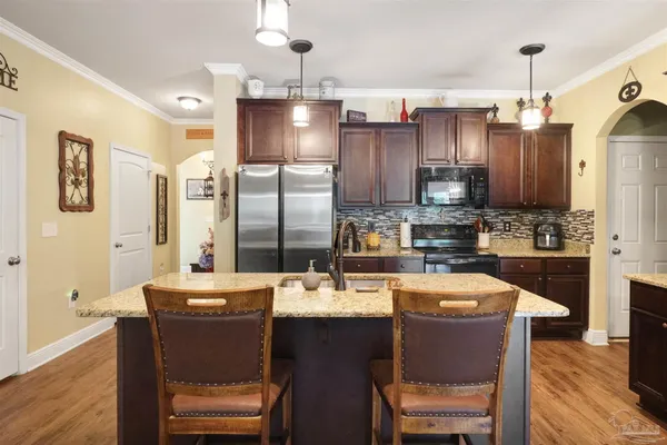 a large kitchen with a table and chairs