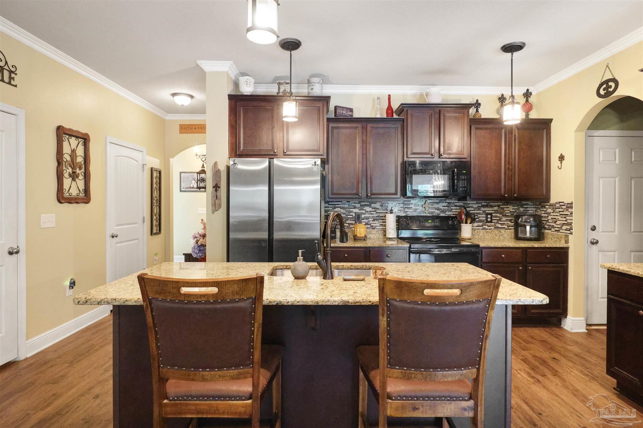 6377 Ladera Trail Pace, FL 32571 - Photo 8 of 38 a large kitchen with a table and chairs