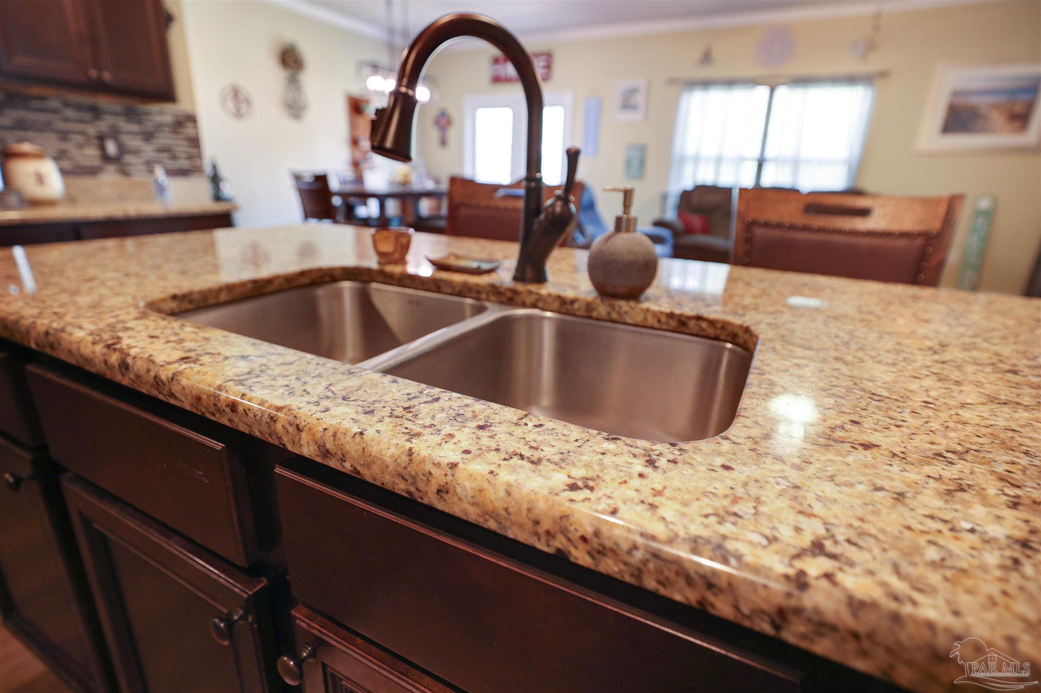 6377 Ladera Trail Pace, FL 32571 - Photo 10 of 38 a kitchen with a sink and a stove with wooden floor