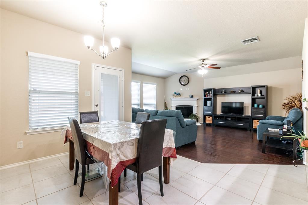 504 Rocky Pine Road McKinney, TX 75072 - Photo 12 of 36 Dining room featuring a ceiling fan, light tile patterned floors, and a fireplace