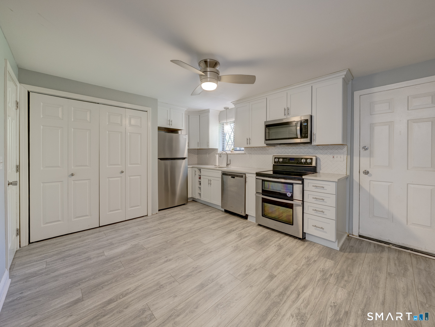 2 Branch Road, Unit 2C Thomaston, CT 06787 - Photo 8 of 26 a kitchen with granite countertop a refrigerator and a stove top oven