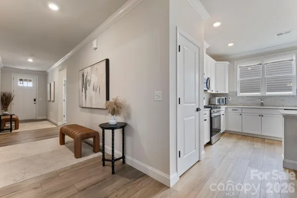 a kitchen with a sink cabinets and wooden floor
