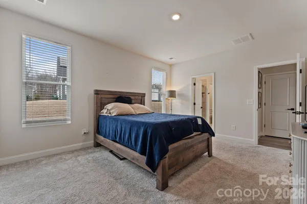 a spacious bedroom with a bed and a window