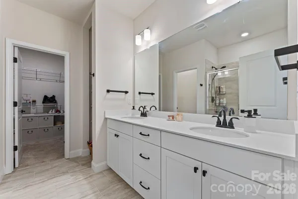a bathroom with a double vanity sink and mirror