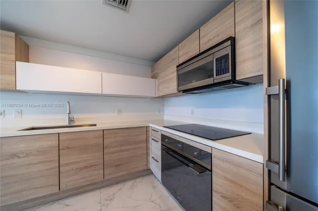 a kitchen with a refrigerator and an oven