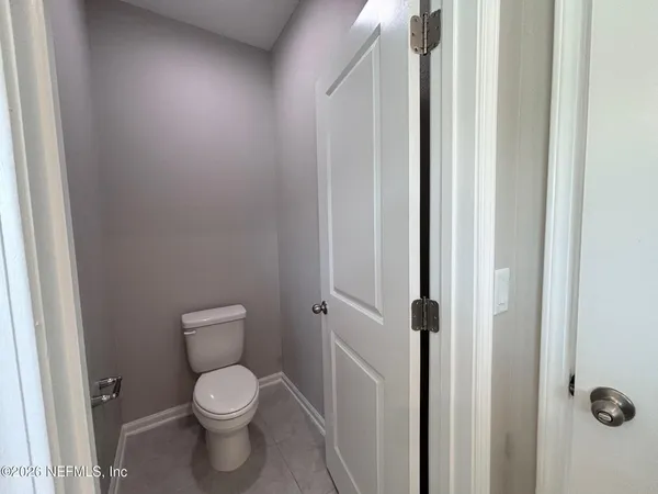 a white toilet sitting next to a shower