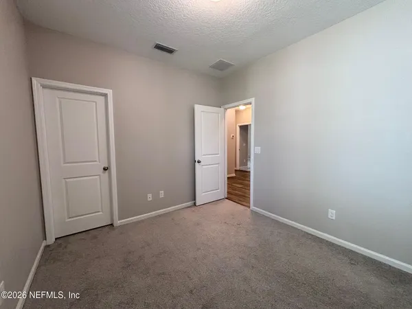 an empty room with closet area