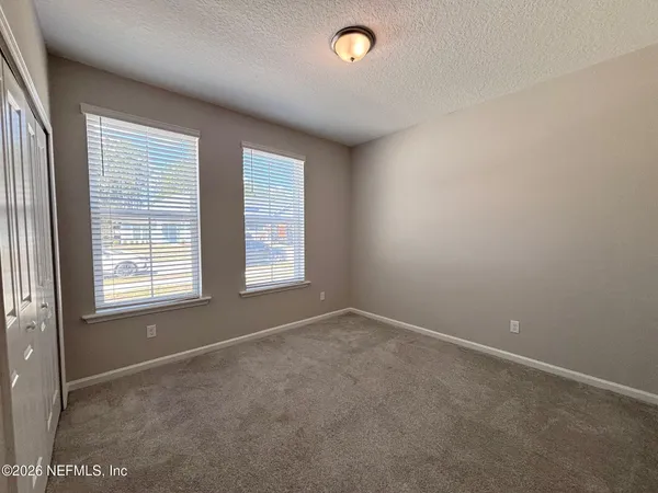 an empty room with a empty space and windows