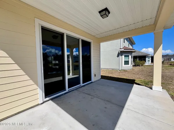 a view of a patio with a table and chairs