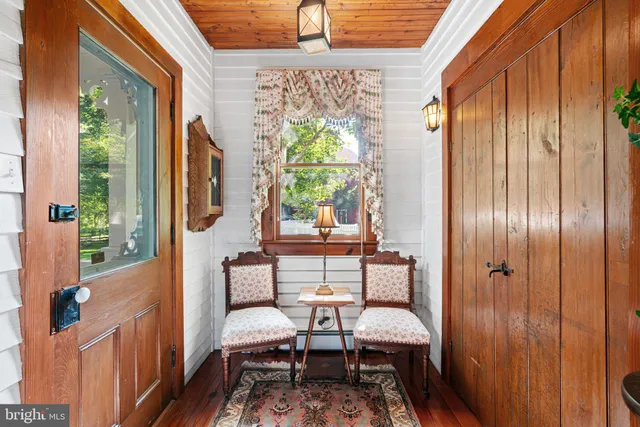 a living room with furniture a window and a chandelier