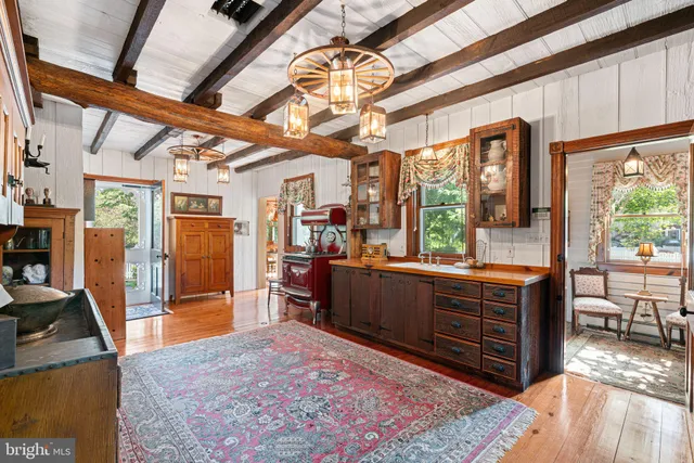 a view of a dining room with furniture a chandelier and wooden floor