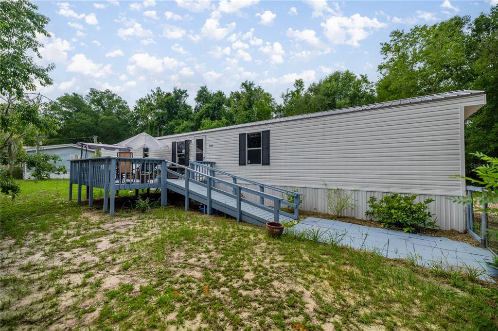 a backyard of a house with table and chairs