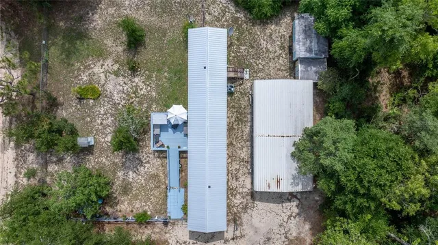 an aerial view of a house with outdoor space
