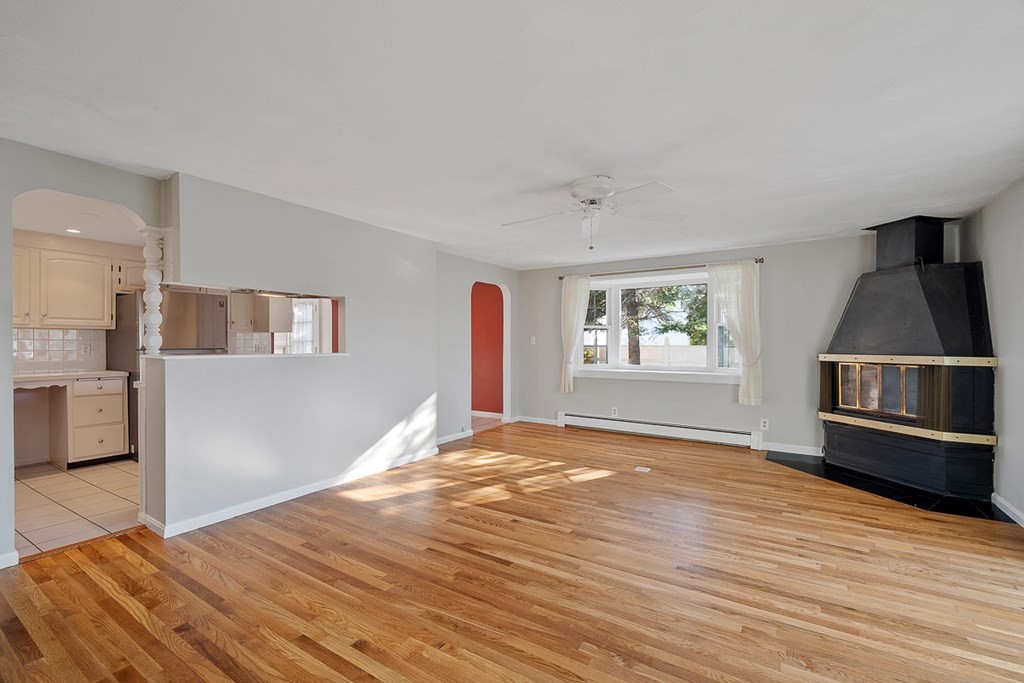 2 Craft Road Natick, MA 01760 - Photo 14 of 42 a view of a kitchen with wooden floor and a fireplace