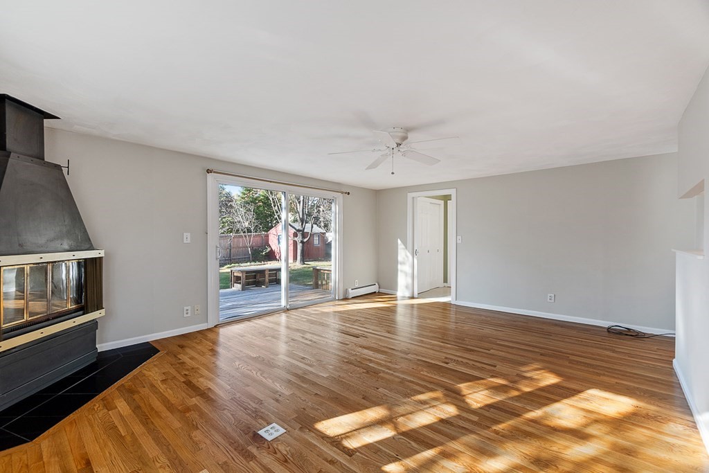 2 Craft Road Natick, MA 01760 - Photo 17 of 42 a view of an empty room with wooden floor and a window
