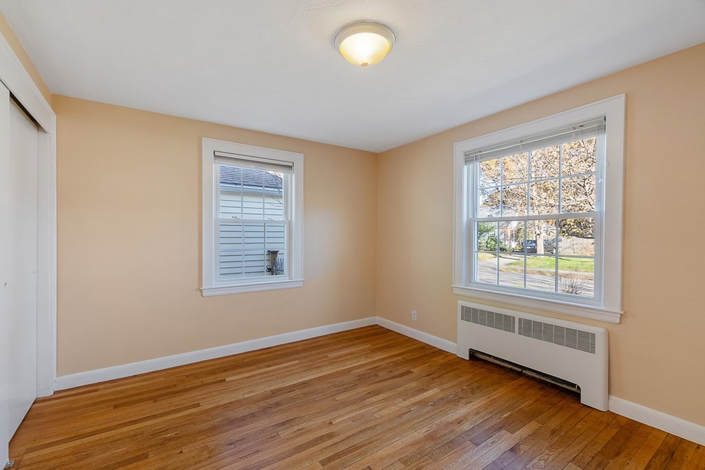 2 Craft Road Natick, MA 01760 - Photo 18 of 42 a view of an empty room with wooden floor and a window
