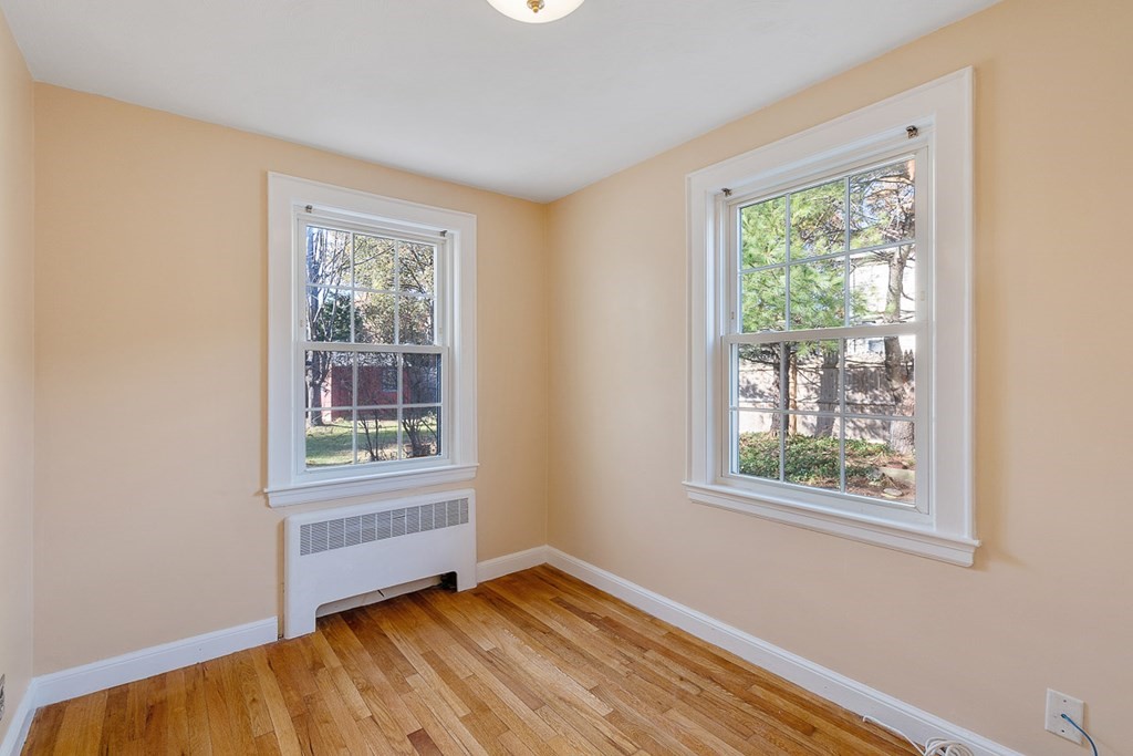 2 Craft Road Natick, MA 01760 - Photo 20 of 42 a view of an empty room with wooden floor and a window