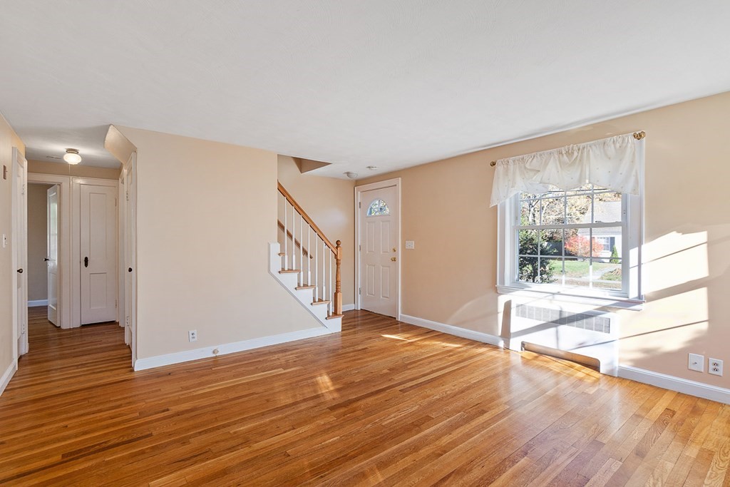 2 Craft Road Natick, MA 01760 - Photo 6 of 42 a view of an empty room with wooden floor and a window