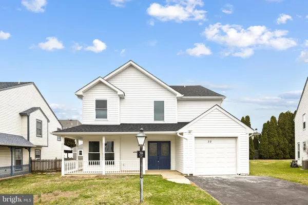 a view of a white house with a yard