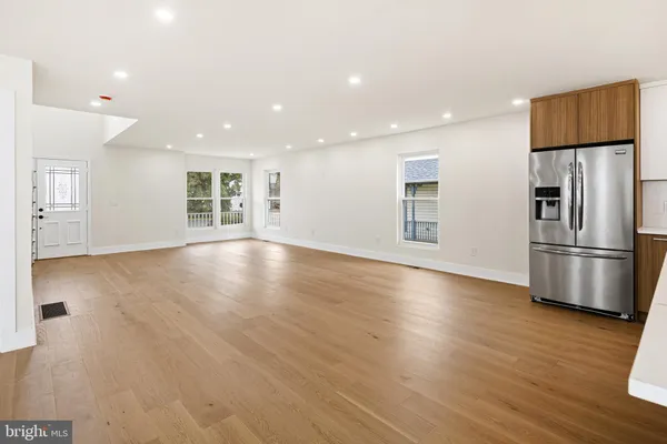 a kitchen with stainless steel appliances a refrigerator sink and microwave
