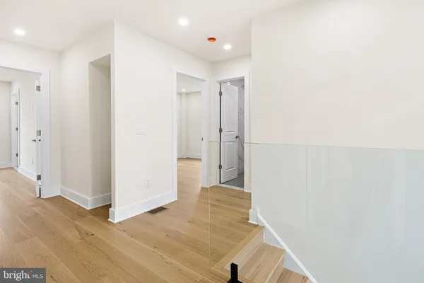 a view of a hallway with wooden floor