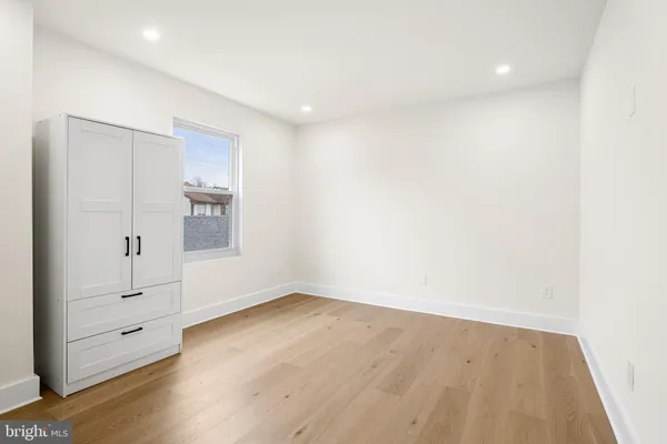 a bedroom with a bed and a chair
