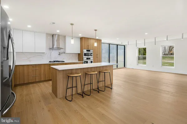 a large kitchen with a table and chairs