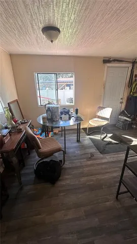 a kitchen with granite countertop a stove and white cabinets