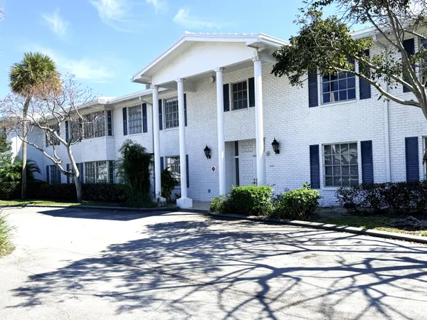 a view of a white house with a yard