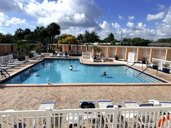 a view of swimming pool with furniture