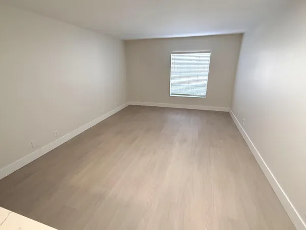 a view of a workspace with furniture and a flat screen tv
