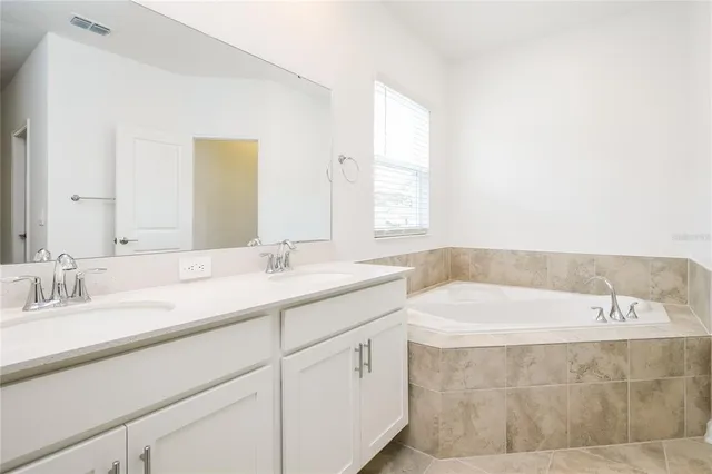 a bathroom with a bathtub and a sink