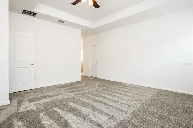 a view of a room with a ceiling fan