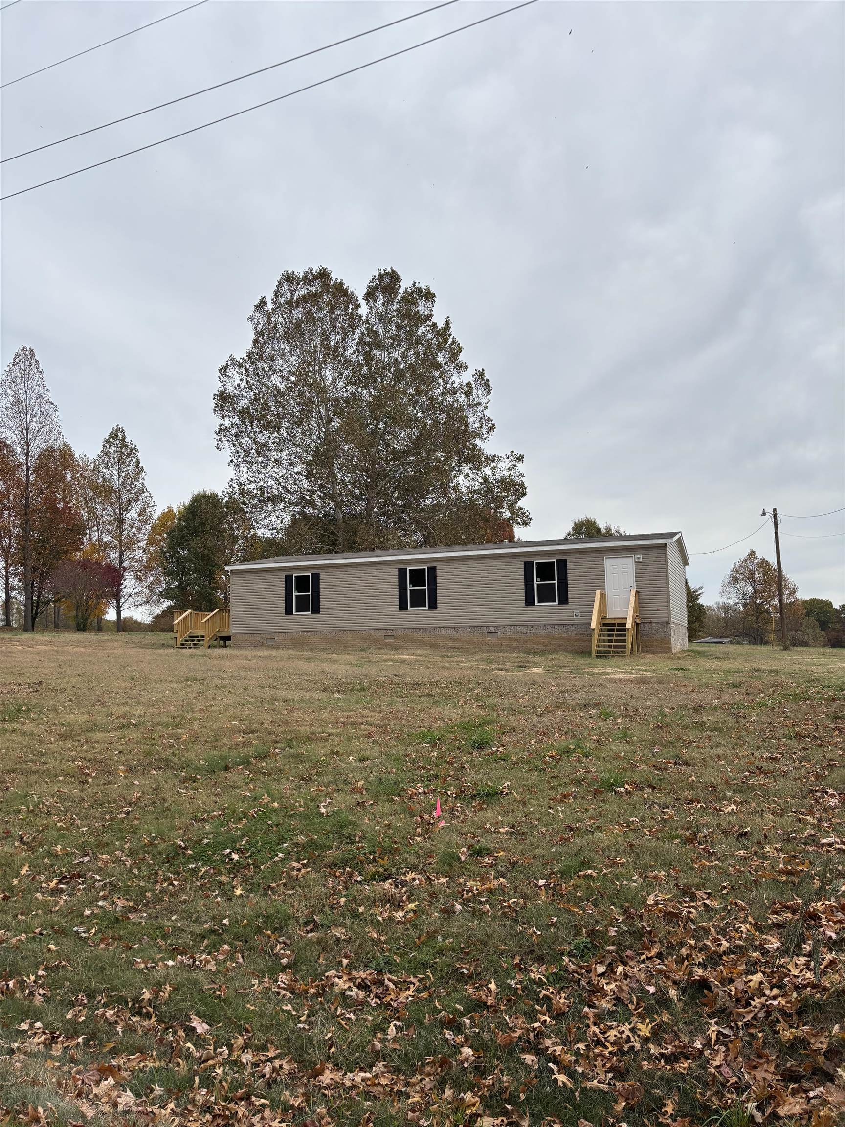 1131 Hobe Webb Road Ripley, TN 38063 - Photo 12 of 27 a front view of a house with a yard
