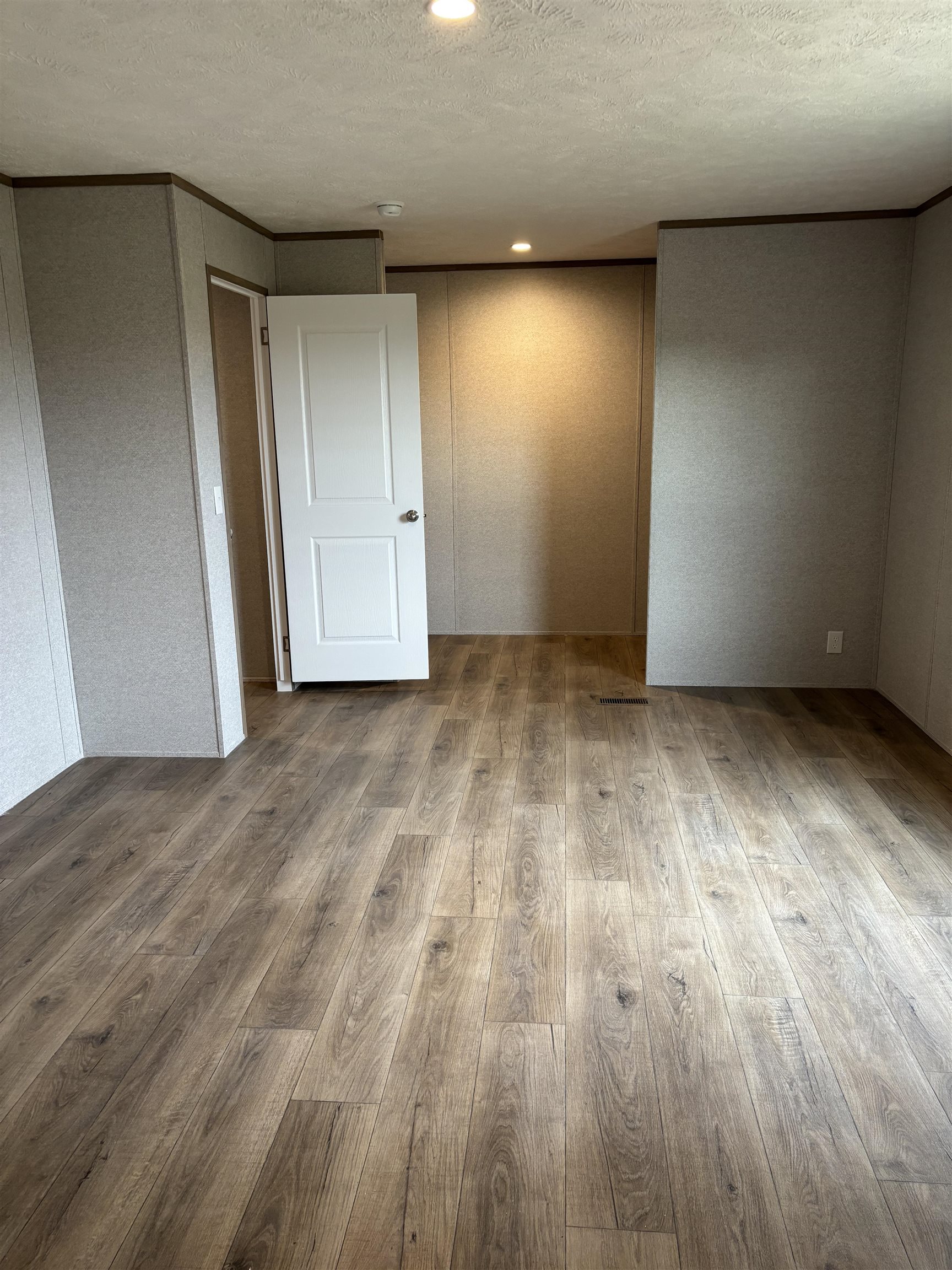 1131 Hobe Webb Road Ripley, TN 38063 - Photo 19 of 27 an empty room with wooden floor and windows