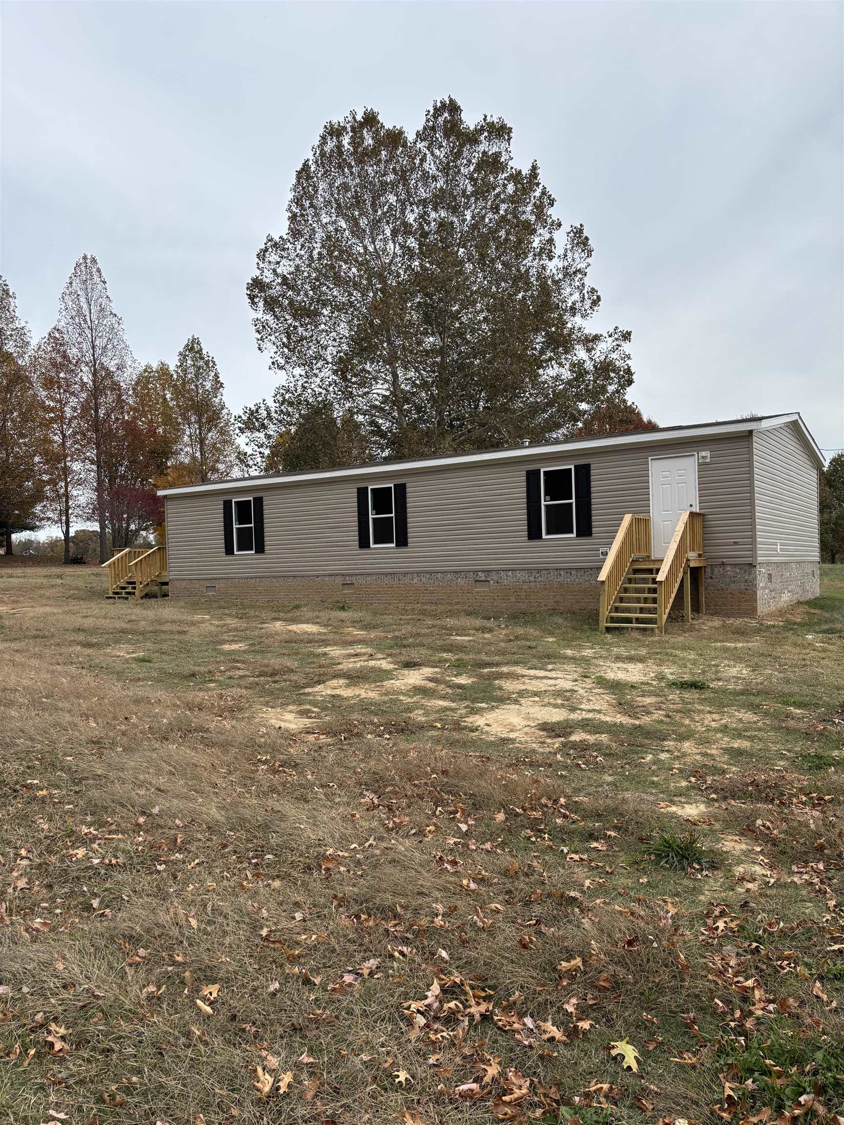 1131 Hobe Webb Road Ripley, TN 38063 - Photo 2 of 27 a backyard of a house with table and chairs