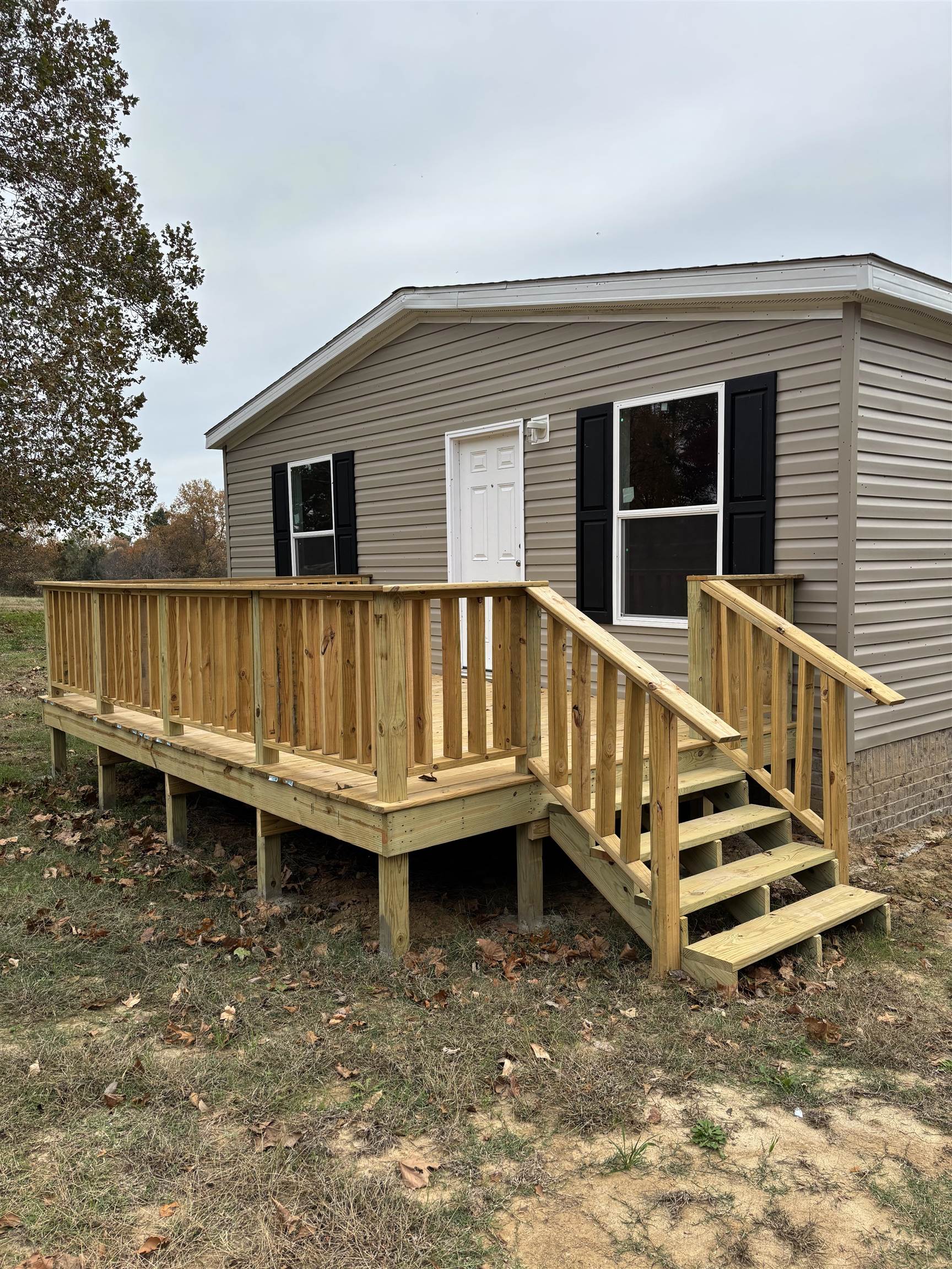 1131 Hobe Webb Road Ripley, TN 38063 - Photo 7 of 27 a view of a house with wooden deck and furniture