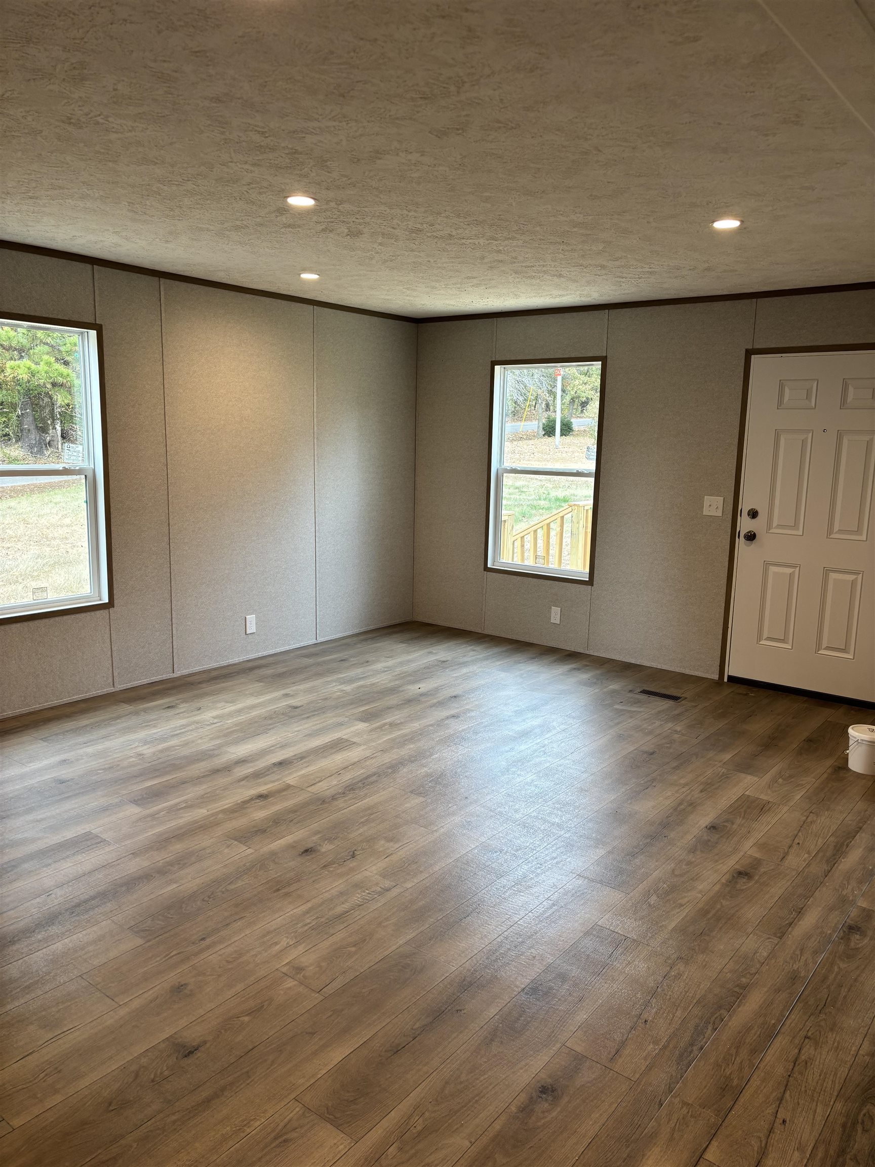1131 Hobe Webb Road Ripley, TN 38063 - Photo 10 of 27 an empty room with wooden floor and windows