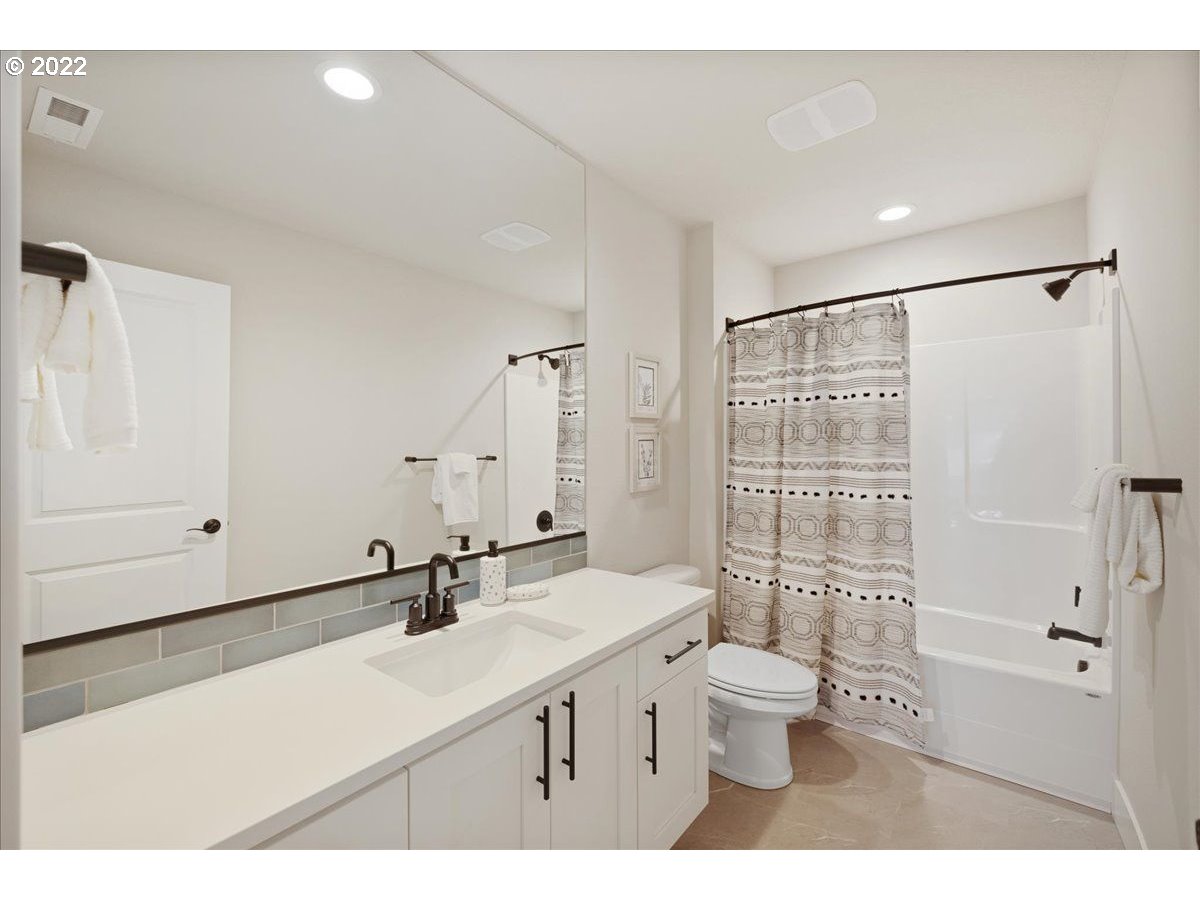 520 North Russet Place, Unit LT28 Ridgefield, WA 98642 - Photo 23 of 24 a bathroom with a sink a toilet a mirror and shower